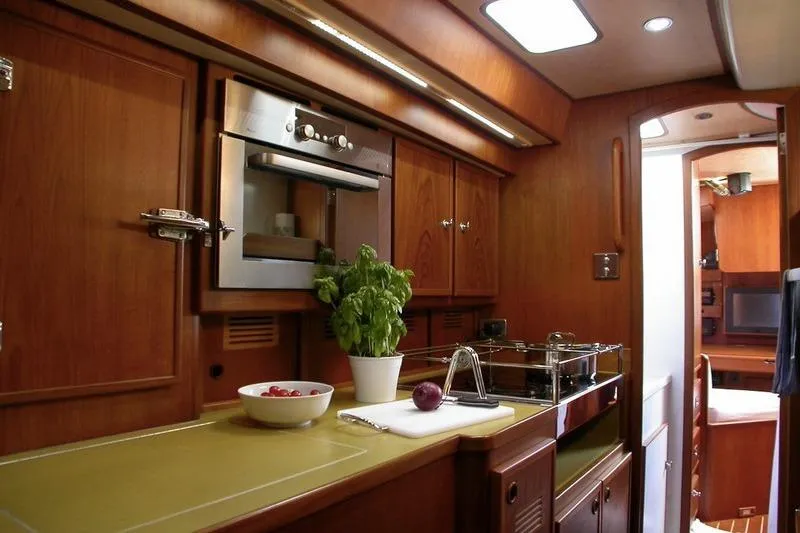 Matchless Yacht Photos Pics Luxurious wooden kitchen interior of 1982 Ron Holland 68 yacht by Chantier Naval de l&rsquo;Anitra.