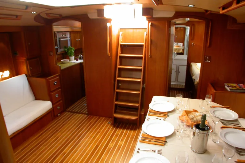 Matchless Yacht Photos Pics Luxurious interior of 1982 Chantier Naval de l&rsquo;Anitra RON HOLLAND 68 yacht, featuring dining area.