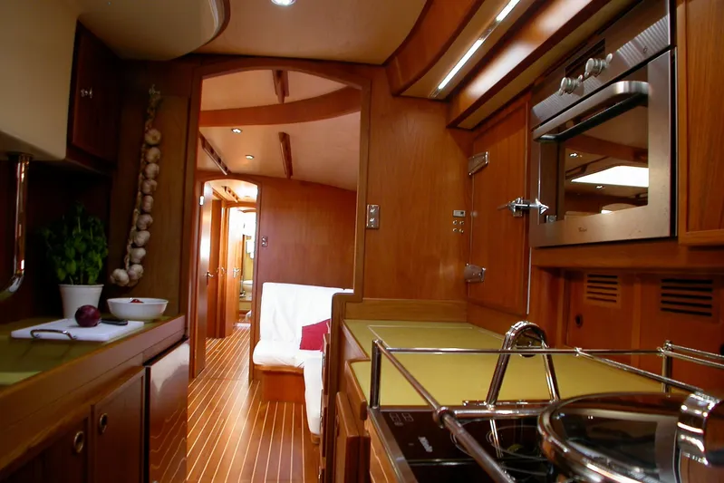 Matchless Yacht Photos Pics Luxurious wooden interior of 1982 Chantier Naval de l&rsquo;Anitra RON HOLLAND 68 yacht kitchen.