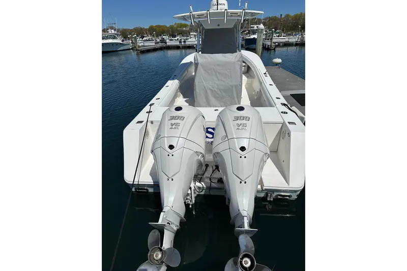 Asia Yacht Photos Pics 2005 Regulator 32 Forward Seating boat with twin 300 V6 engines docked at marina.