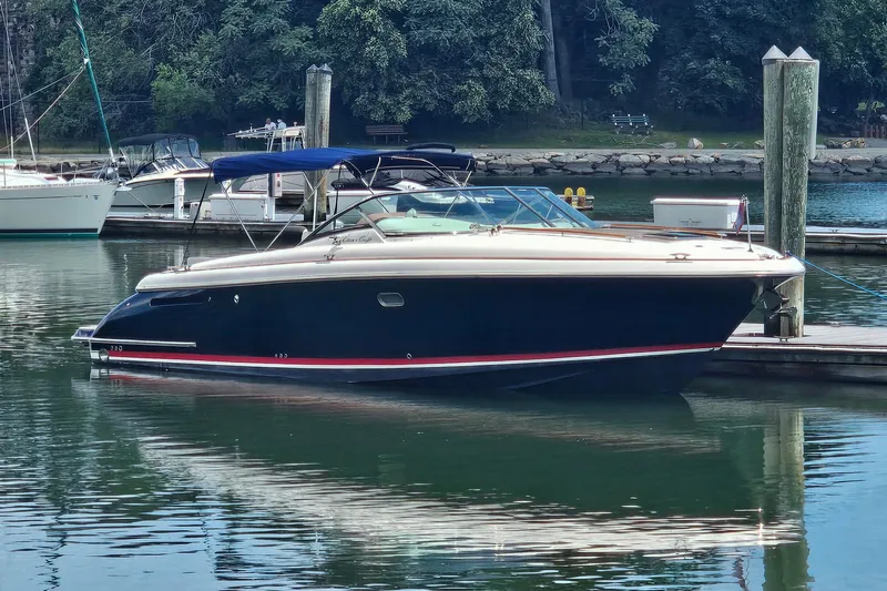 Taipan Yacht Photos Pics 2006 Chris-Craft Corsair 36 boat docked in a serene marina setting.