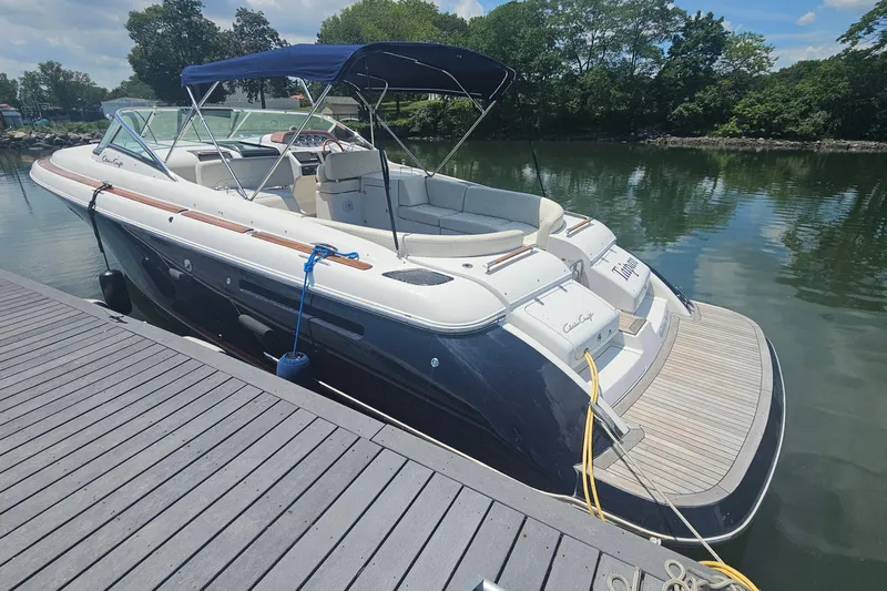 Taipan Yacht Photos Pics 2006 Chris-Craft Corsair 36 boat docked on a sunny day, featuring sleek design and canopy.