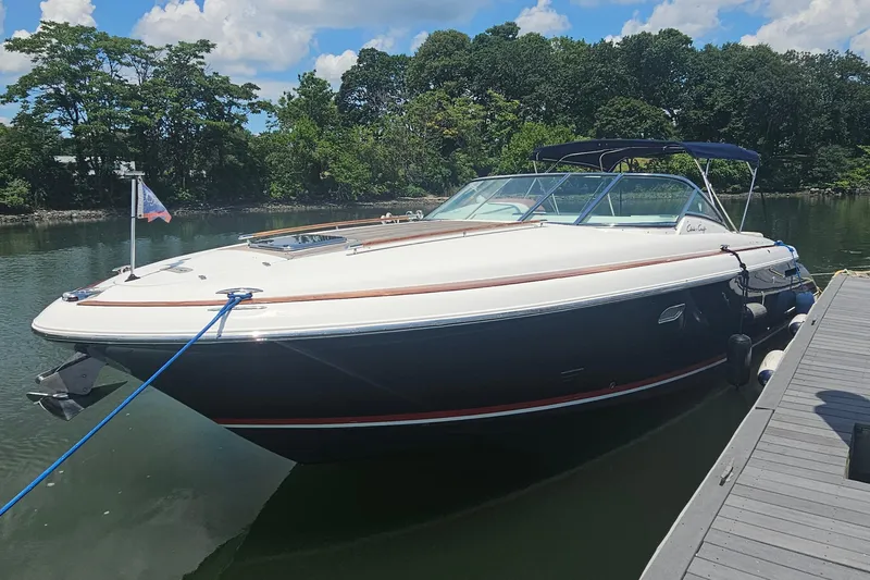 Taipan Yacht Photos Pics 2006 Chris-Craft Corsair 36 boat docked on a sunny day with lush greenery.
