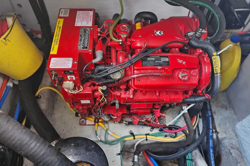 Taipan Yacht Photos Pics Engine compartment of a 2006 Chris-Craft Corsair 36, featuring a red marine engine.