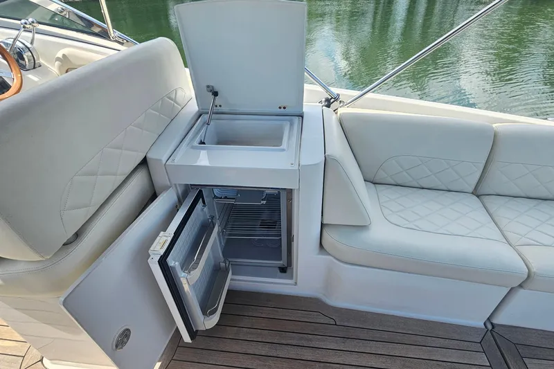 Taipan Yacht Photos Pics Luxurious 2006 Chris-Craft Corsair 36 boat interior with sink and mini fridge.