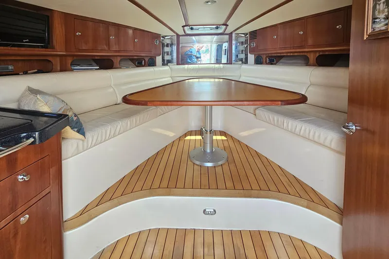 Taipan Yacht Photos Pics Luxurious interior of 2006 Chris-Craft Corsair 36 with elegant wood and leather seating.