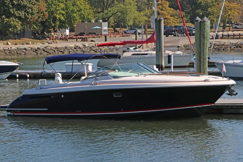 Taipan Yacht Photos Pics 2006 Chris-Craft Corsair 36 boat docked in a marina, surrounded by other vessels.