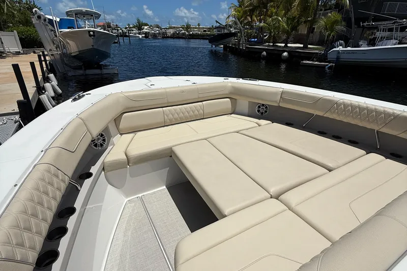  Yacht Photos Pics Luxurious seating area on 2022 Regal 38 SAV boat docked by the water.
