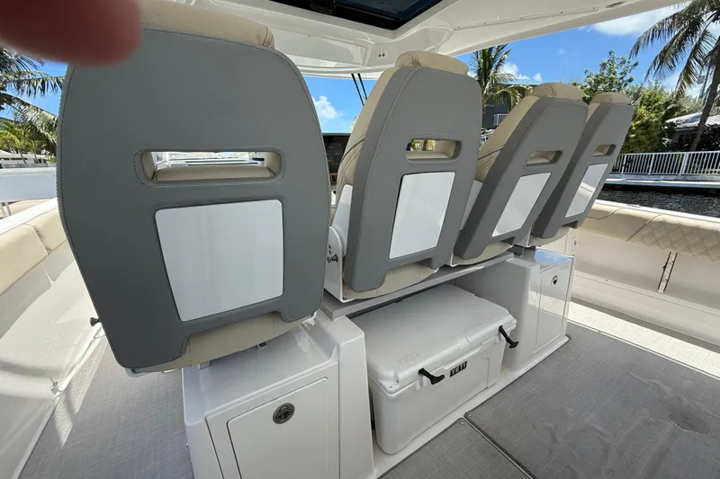  Yacht Photos Pics 2022 Regal 38 SAV boat interior with seating and storage, featuring a Yeti cooler.