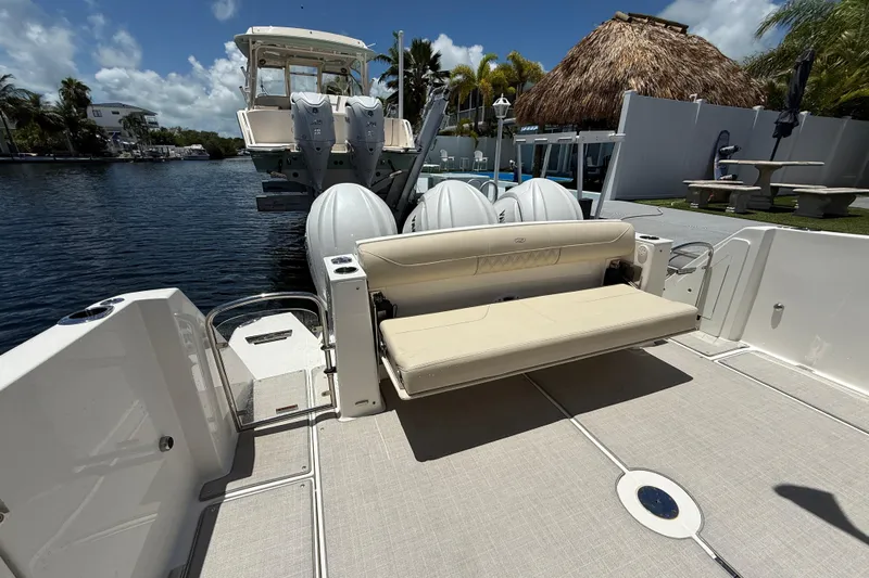  Yacht Photos Pics 2022 Regal 38 SAV boat with seating and powerful outboard engines docked by the water.