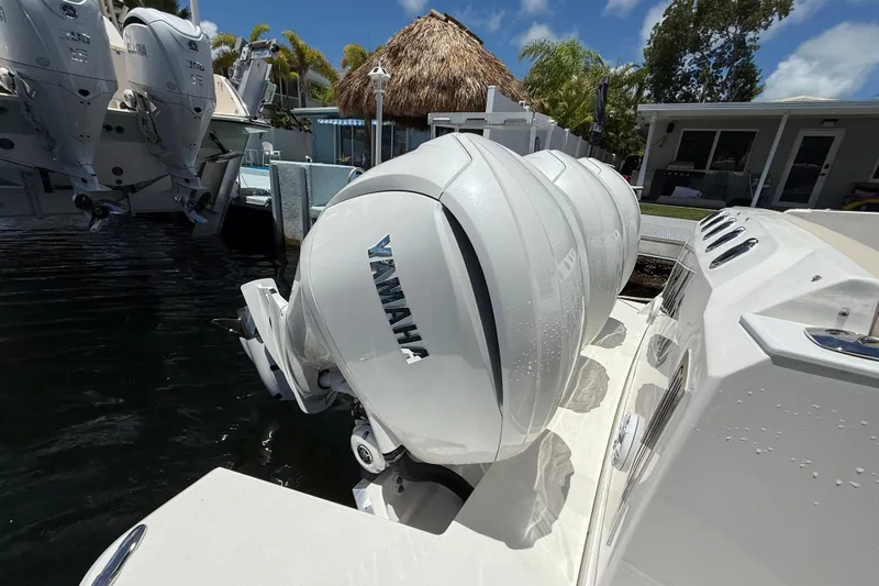  Yacht Photos Pics 2022 Regal 38 SAV boat with Yamaha outboard engines docked by waterfront.