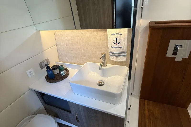 Yacht Photos Pics Modern bathroom in 2022 Regal 38 SAV yacht with stylish sink and nautical decor.