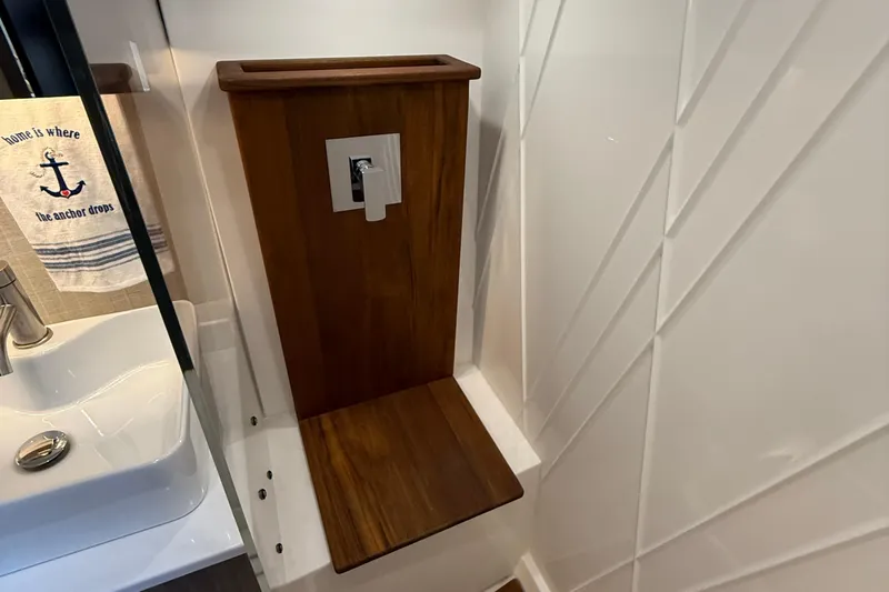  Yacht Photos Pics 2022 Regal 38 SAV bathroom with wooden panel and modern sink design.