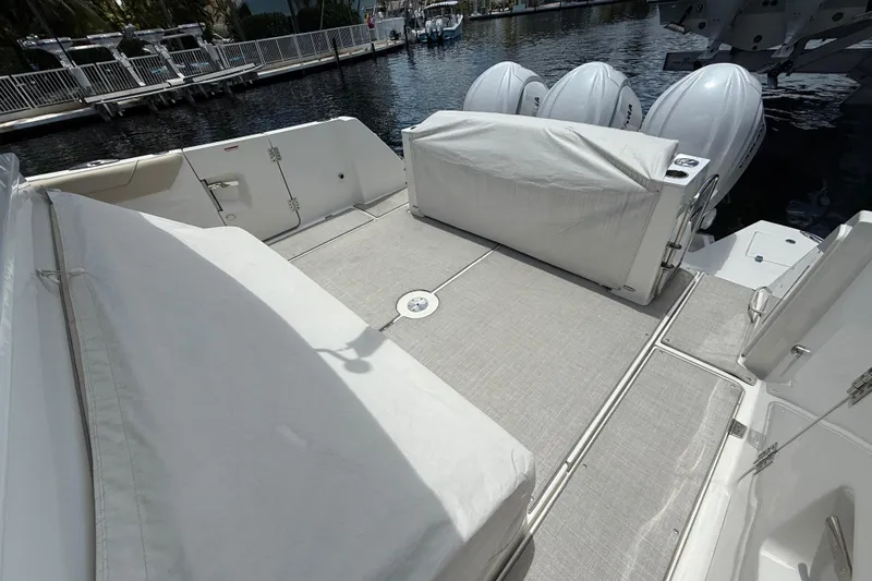  Yacht Photos Pics 2022 Regal 38 SAV boat deck with covered seating and outboard engines.