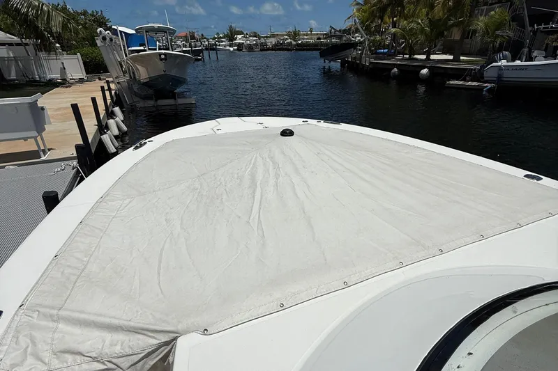  Yacht Photos Pics 2022 Regal 38 SAV boat with covered bow, docked in a marina.