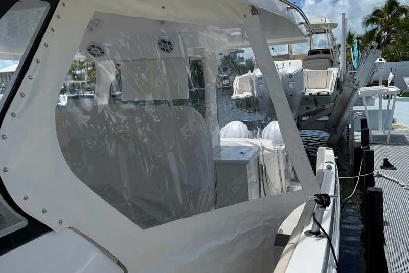  Yacht Photos Pics 2022 Regal 38 SAV boat docked, featuring clear enclosure and modern design.