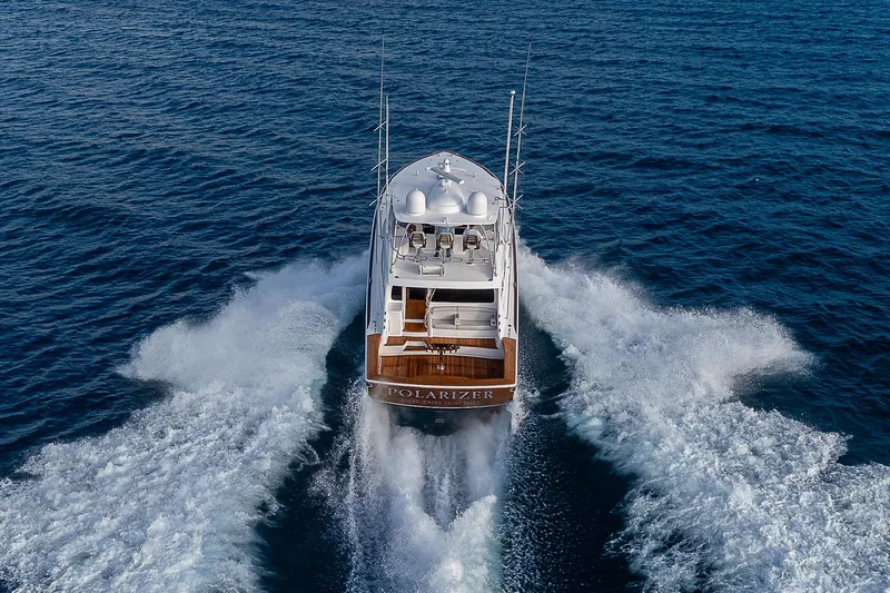 South Jersey Yacht Sales Demo Boat Yacht Photos Pics 2025 Viking 64 Convertible yacht cruising on open sea, rear view.