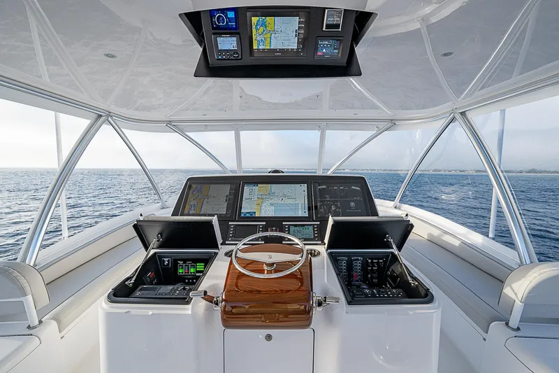 South Jersey Yacht Sales Demo Boat Yacht Photos Pics 2025 Viking 64 Convertible yacht helm with advanced navigation systems on open sea.