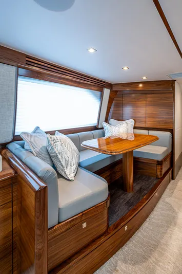 South Jersey Yacht Sales Demo Boat Yacht Photos Pics Luxurious interior of 2025 Viking 64 Convertible yacht with elegant wood finish and plush seating.