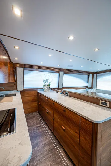 South Jersey Yacht Sales Demo Boat Yacht Photos Pics Luxurious interior of 2025 Viking 64 Convertible yacht with modern kitchen design.