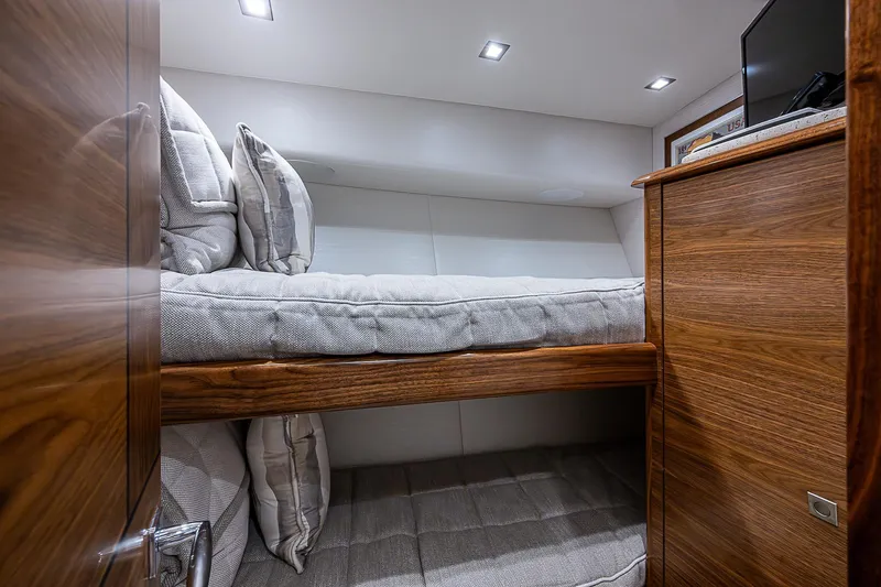 South Jersey Yacht Sales Demo Boat Yacht Photos Pics Luxurious bunk beds in 2025 Viking 64 Convertible yacht cabin.