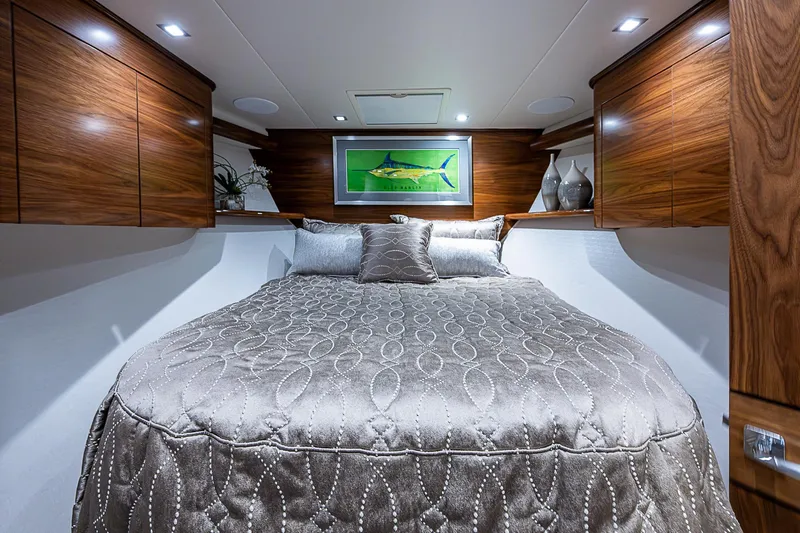 South Jersey Yacht Sales Demo Boat Yacht Photos Pics Luxurious bedroom interior of 2025 Viking 64 Convertible yacht with elegant wood finishes.