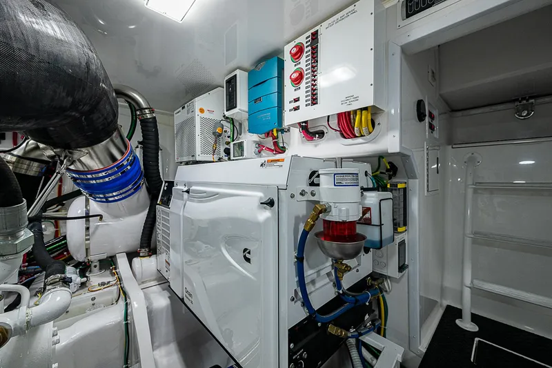 South Jersey Yacht Sales Demo Boat Yacht Photos Pics Engine room of 2025 Viking 64 Convertible yacht, showcasing advanced machinery and controls.