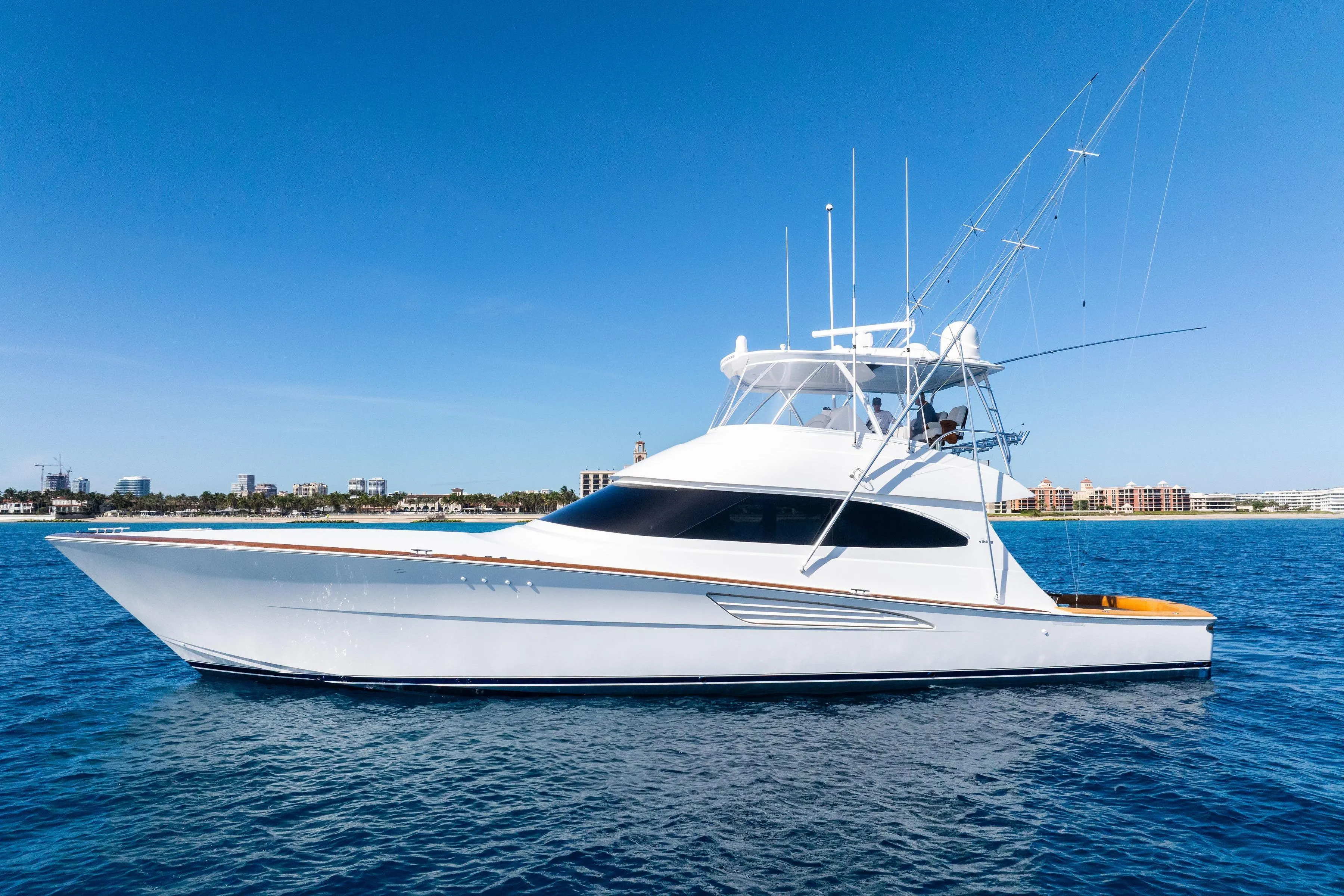 2025 Viking 64 Convertible yacht on calm blue ocean waters.