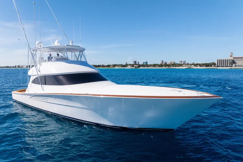  Yacht Photos Pics 2025 Viking 64 Convertible yacht cruising on clear blue ocean waters.