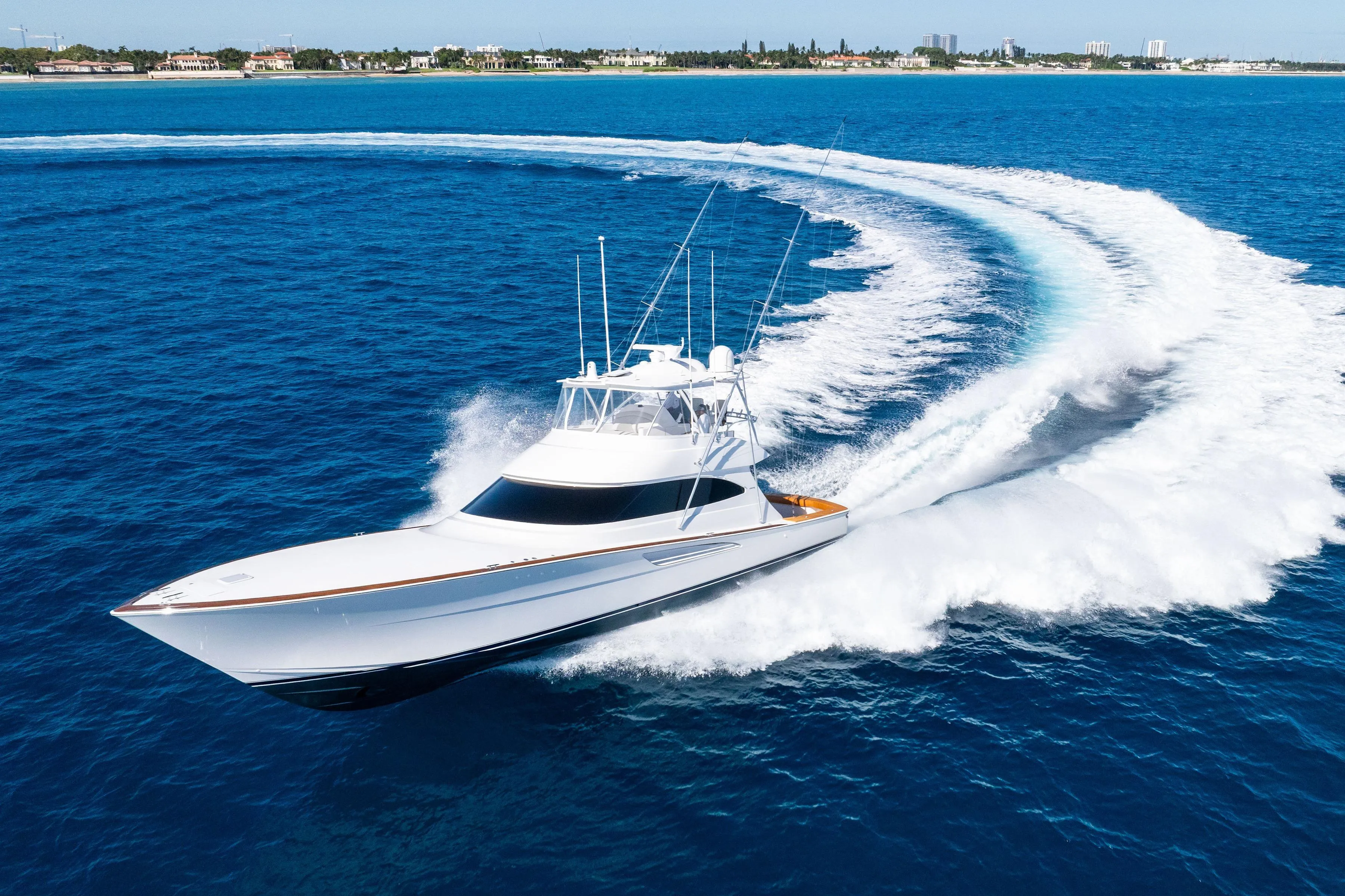 2025 Viking 64 Convertible yacht cruising swiftly on open blue ocean waters.