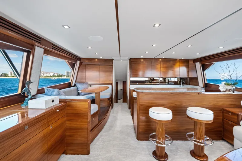  Yacht Photos Pics Luxurious interior of 2025 Viking 64 Convertible yacht with elegant wood finishes and ocean view.