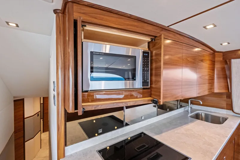  Yacht Photos Pics Modern kitchen in 2025 Viking 64 Convertible yacht with microwave and sleek cabinetry.