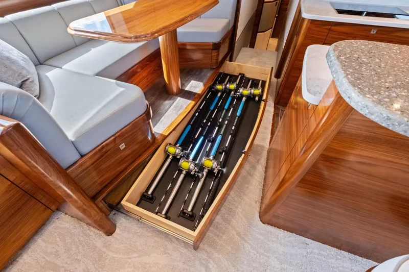  Yacht Photos Pics 2025 Viking 64 Convertible yacht interior with fishing rod storage drawer.
