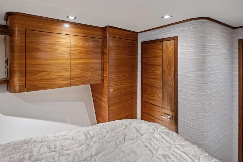  Yacht Photos Pics Luxurious wood interior of 2025 Viking 64 Convertible yacht bedroom.