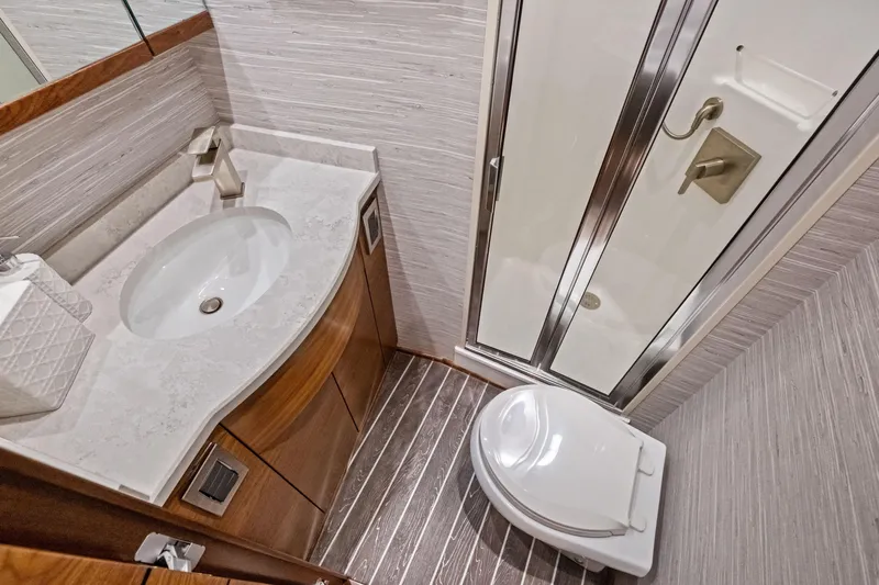  Yacht Photos Pics Luxurious bathroom in 2025 Viking 64 Convertible yacht with modern fixtures and elegant design.