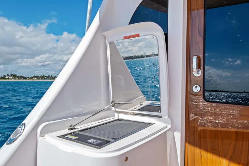  Yacht Photos Pics 2025 Viking 64 Convertible yacht with outdoor grill and ocean view.