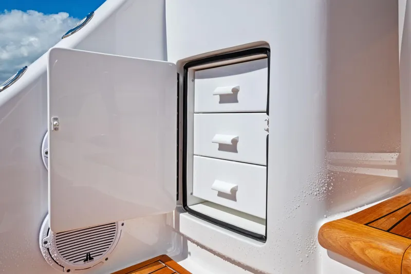  Yacht Photos Pics 2025 Viking 64 Convertible yacht storage compartment with open door and drawers.