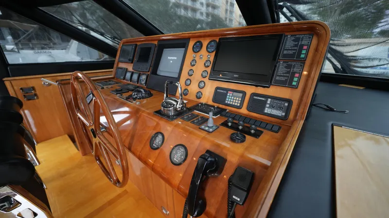 4 Princesses Yacht Photos Pics Helm station of 2002 Queenship 70 Baretta yacht with wooden dashboard and modern navigation equipment.