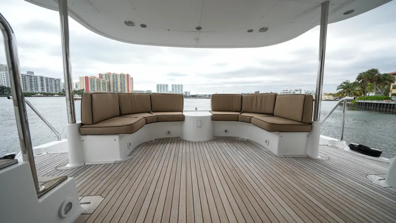 4 Princesses Yacht Photos Pics Spacious deck seating on a 2002 Queenship 70 Baretta yacht with waterfront views.