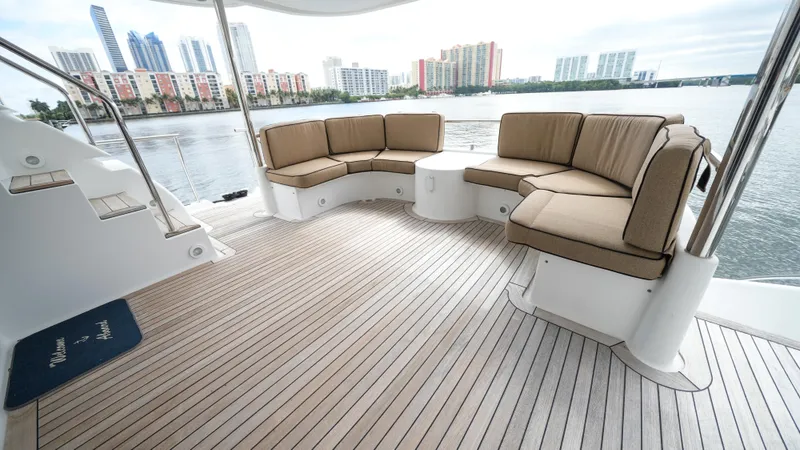4 Princesses Yacht Photos Pics Luxurious seating area on a 2002 Queenship 70 Baretta yacht with waterfront city view.