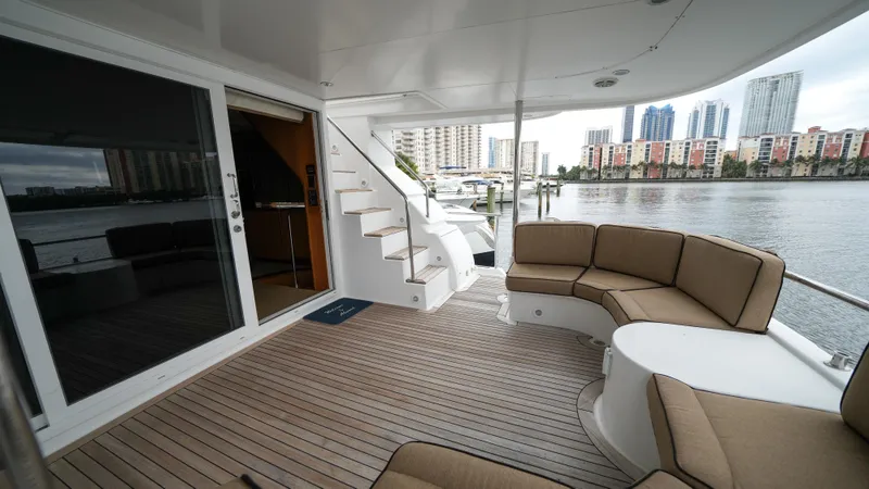 4 Princesses Yacht Photos Pics Luxury deck of 2002 Queenship 70 Baretta yacht with city skyline view.