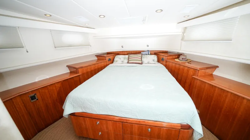 4 Princesses Yacht Photos Pics Luxurious bedroom interior of 2002 Queenship 70 Baretta yacht with wooden cabinetry.