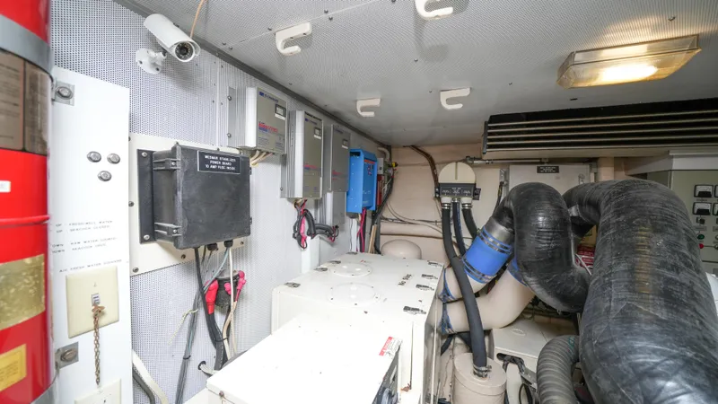 4 Princesses Yacht Photos Pics Engine room of a 2002 Queenship 70 Baretta yacht with various mechanical components.