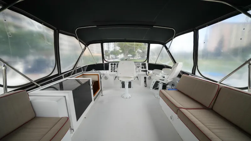 4 Princesses Yacht Photos Pics Interior of 2002 Queenship 70 Baretta yacht with seating and helm station.