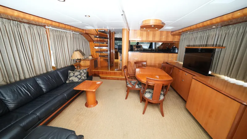 4 Princesses Yacht Photos Pics Luxurious interior of a 2002 Queenship 70 Baretta yacht with elegant wood finishes.