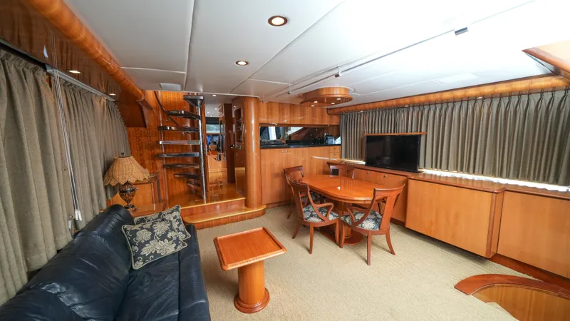 4 Princesses Yacht Photos Pics Luxurious interior of a 2002 Queenship 70 Baretta yacht with elegant wood finishes.