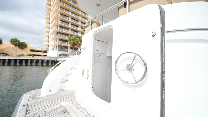 4 Princesses Yacht Photos Pics 2002 Queenship 70 Baretta yacht docked near waterfront buildings.