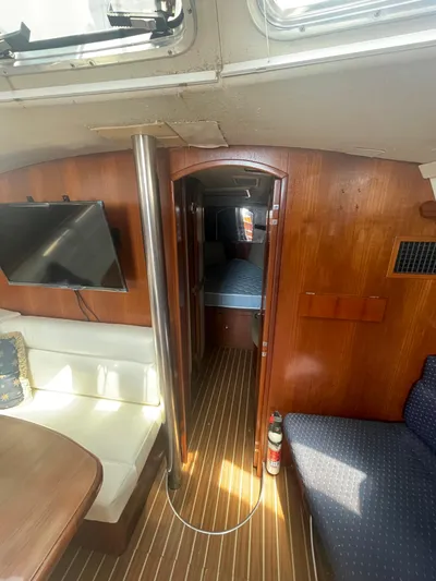 Argo Yacht Photos Pics Interior of 2004 Hunter 44 DS Deck Salon with wood paneling and seating area.