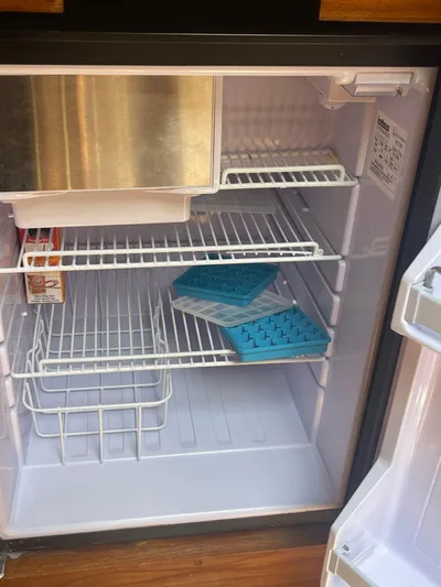 Argo Yacht Photos Pics Open refrigerator with ice trays and baking soda inside.