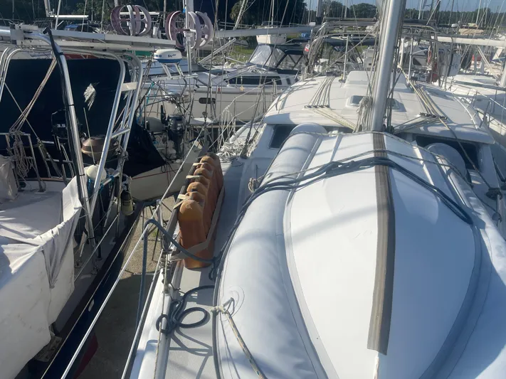 Argo Yacht Photos Pics Hunter 44 DS Deck Salon 2004 sailboat docked among other boats in a marina.